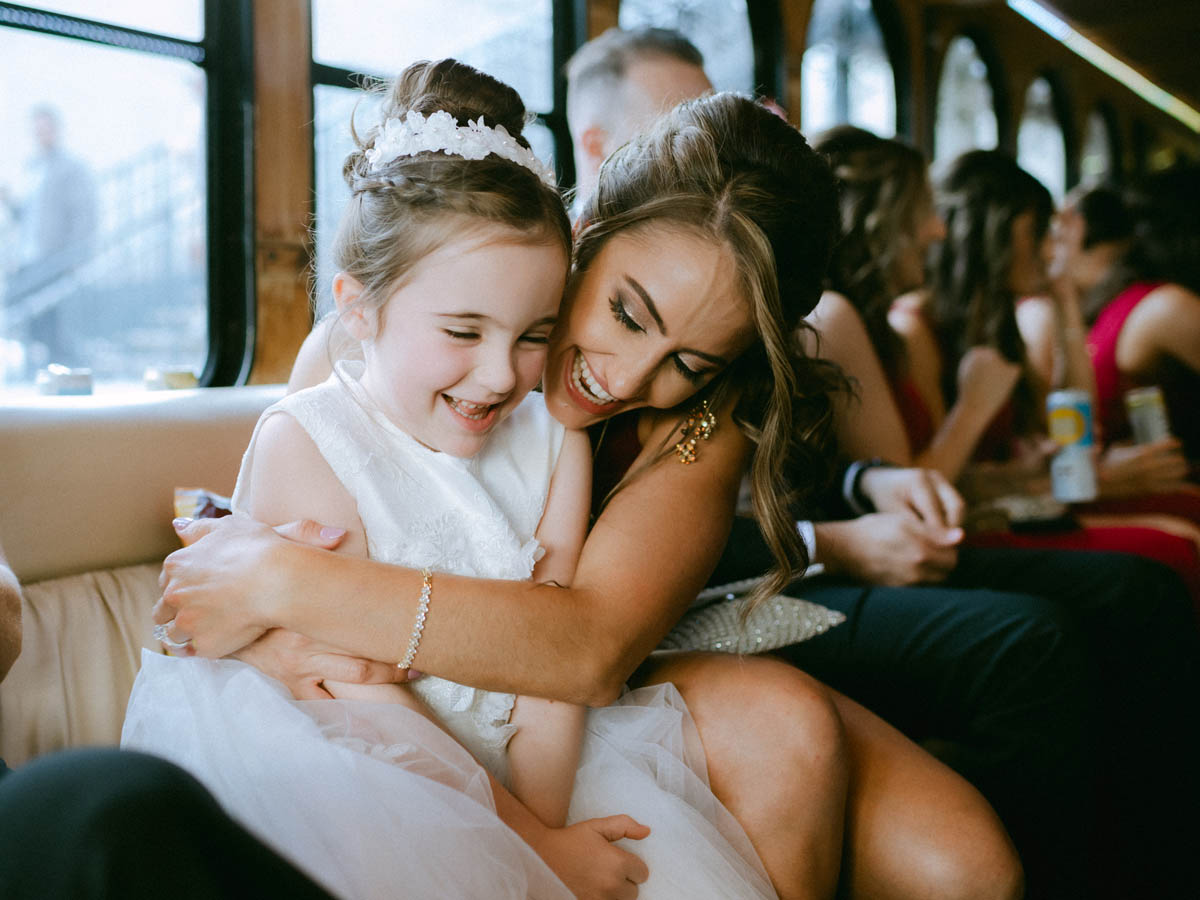 Bridesmaid laughing with flower girl