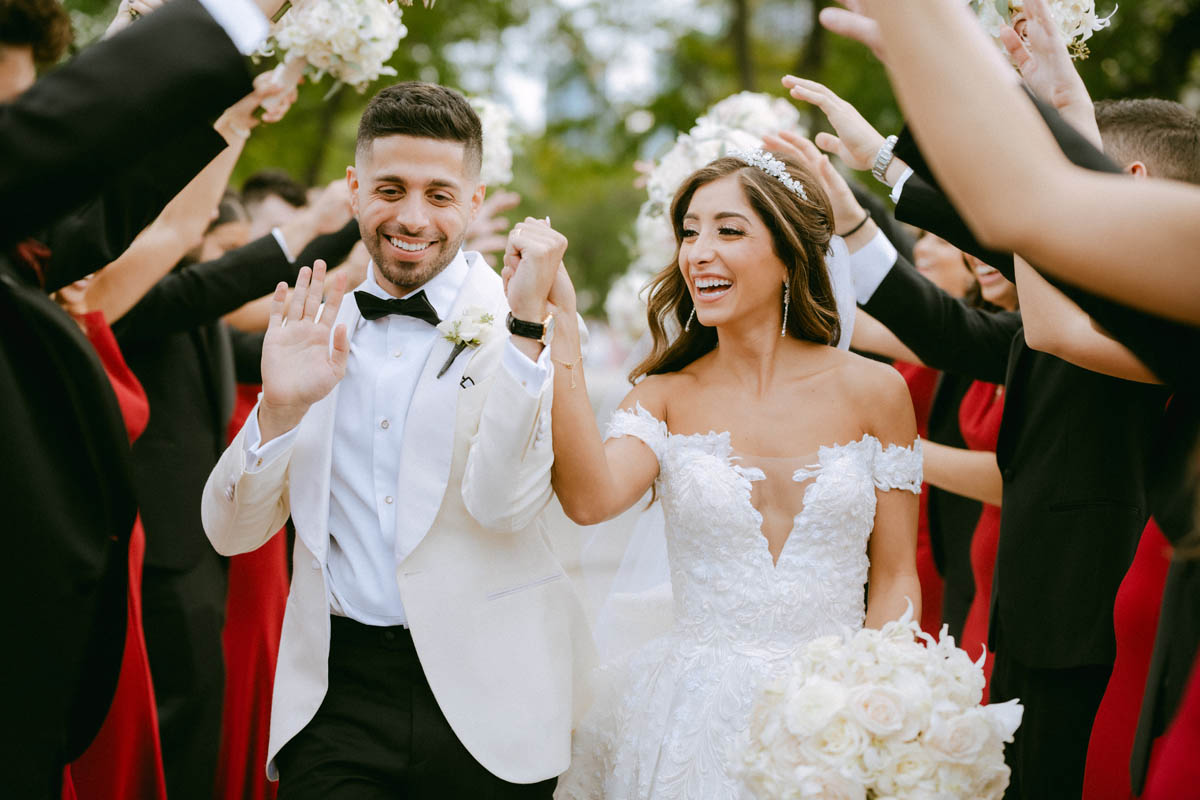 Bride and groom laughing together during their wedding portraits at Olive Park