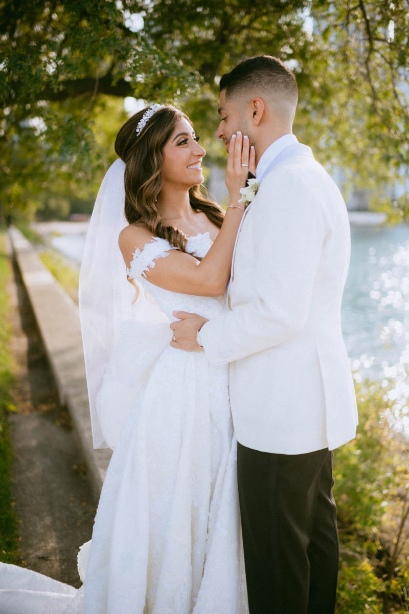 Bride and groom embracing during romantic Chicago wedding portraits at Olive Park