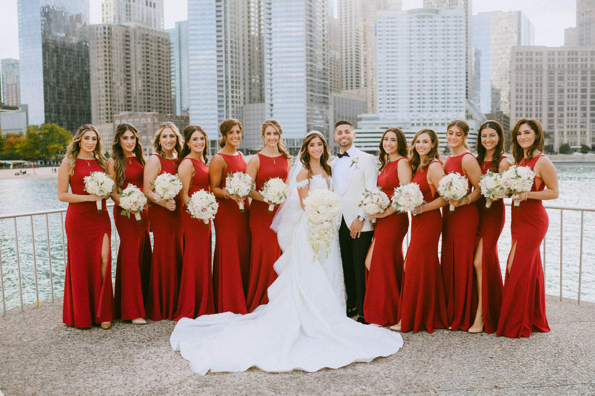 Wedding bridal party wearing red dresses at Olive Park