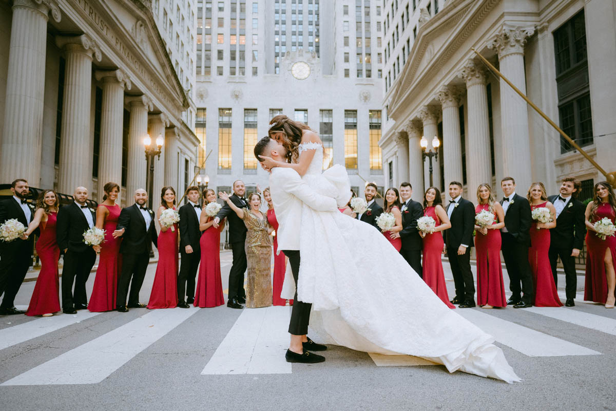 Bride and groom surrounded by their wedding party in downtown Chicago