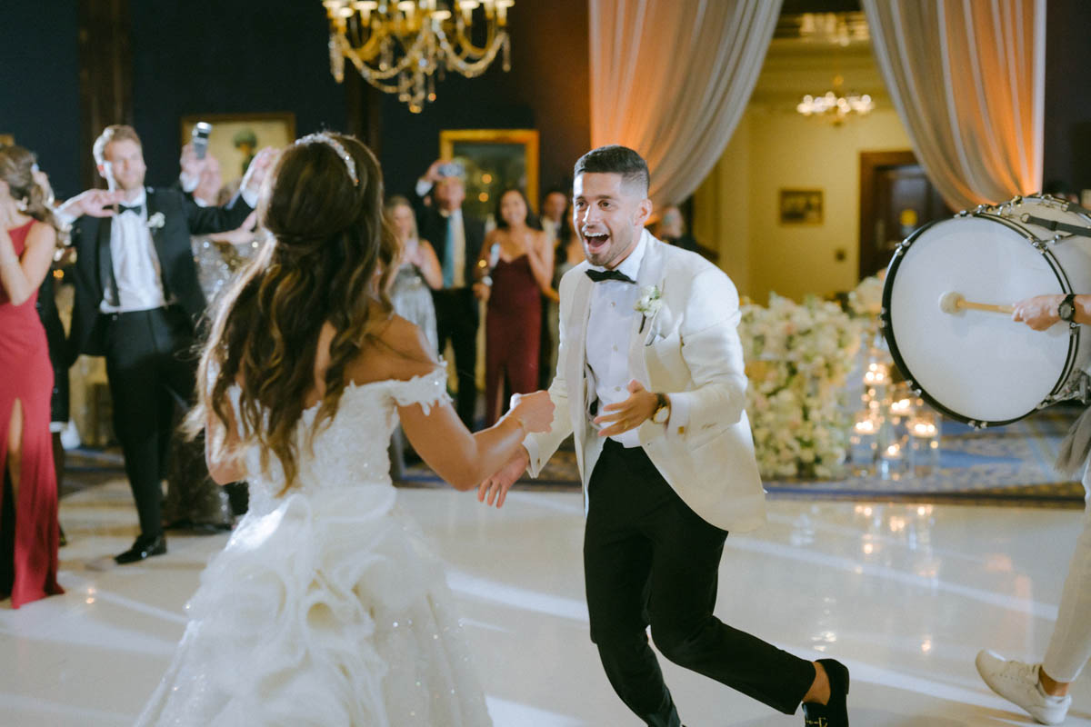 Bride and groom dance with Zaffe band at Union League Club wedding