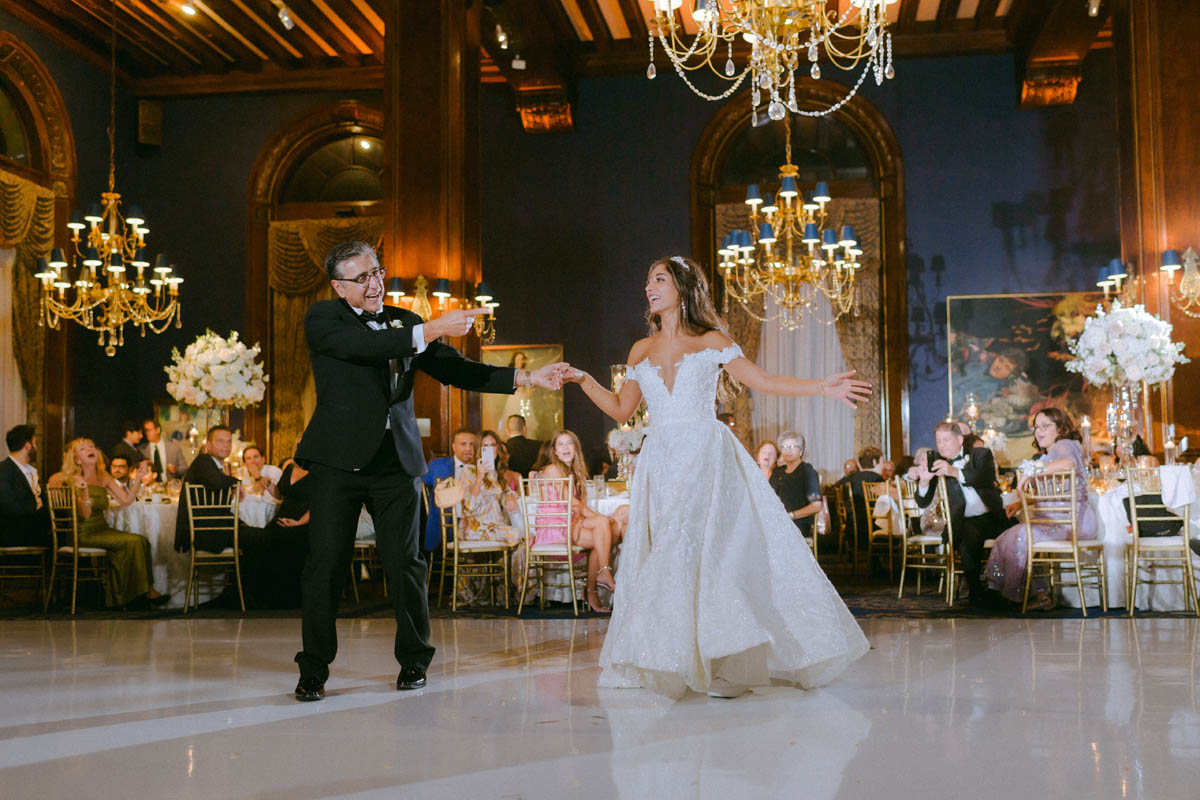 Bride and dad dancing together beneath chandeliers at Union League Club