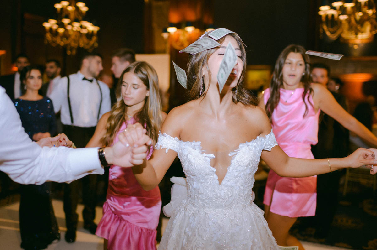 Bride dancing with wedding guests at a Greek wedding reception