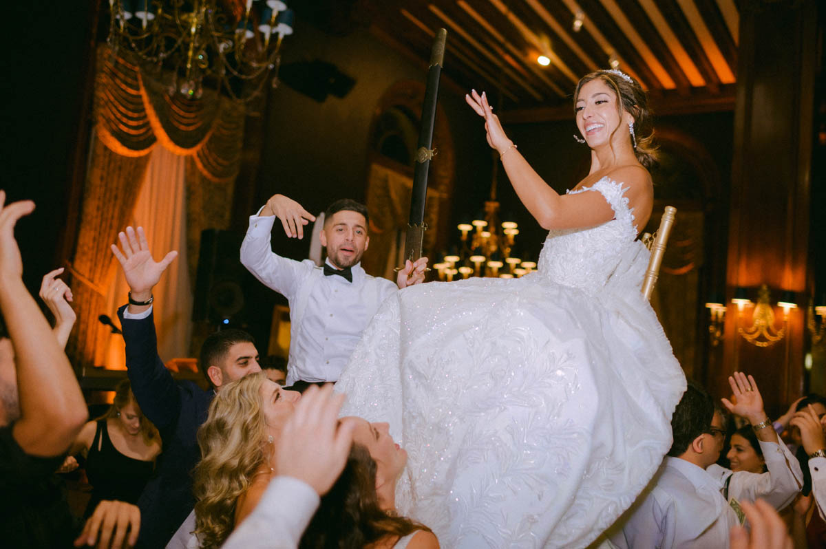Bride dancing with guests during a Greek wedding reception