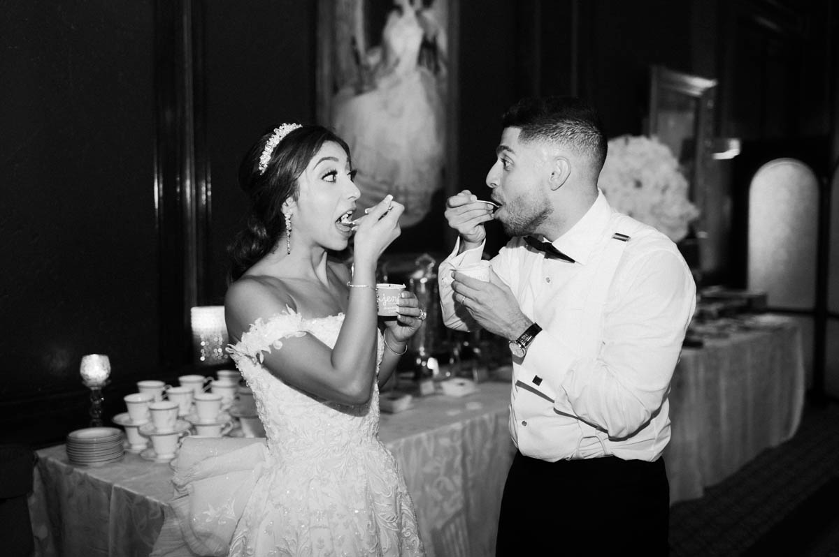 Black and white photo of bride and groom eating Jeni's ice cream