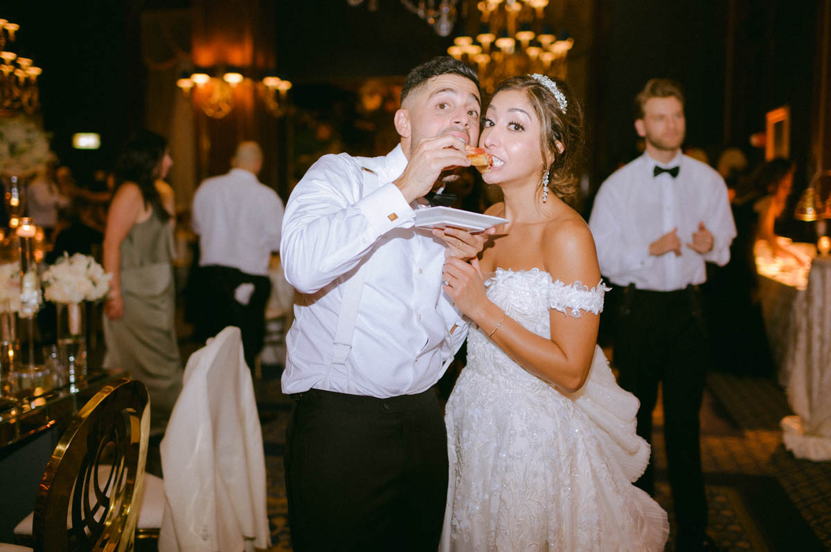 Bride and groom sharing late night pizza
