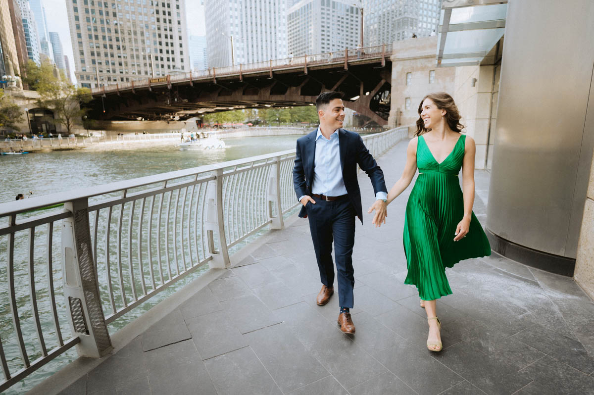 Chicago engagement photo of a couple walking hand in hand along the Chicago River