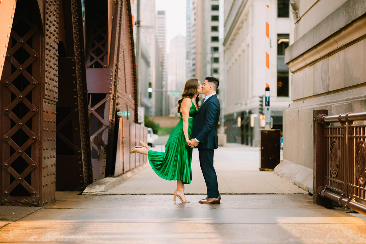 Candid Chicago engagement photo of a couple walking together with their dog
