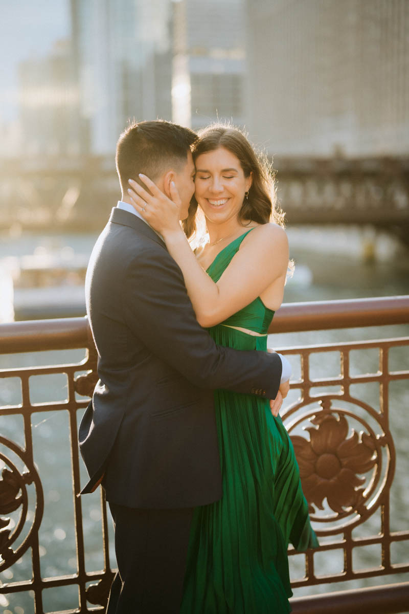 Chicago engagement photo of a couple sharing a kiss on a downtown bridge