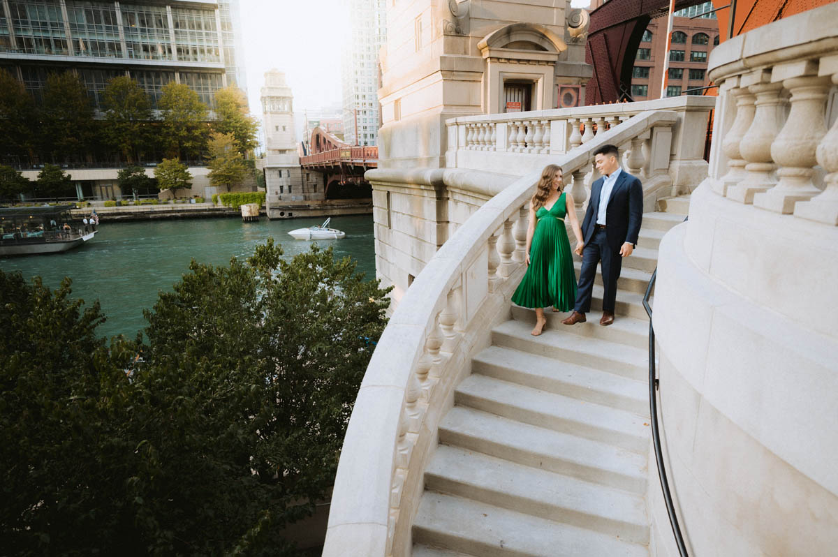 Chicago engagement photos of a couple walking along a grand downtown staircase