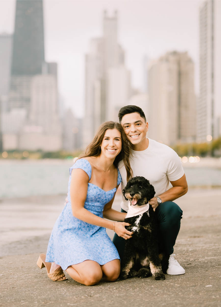 Chicago engagement portrait of a couple with their dog along the Lake Michigan shoreline