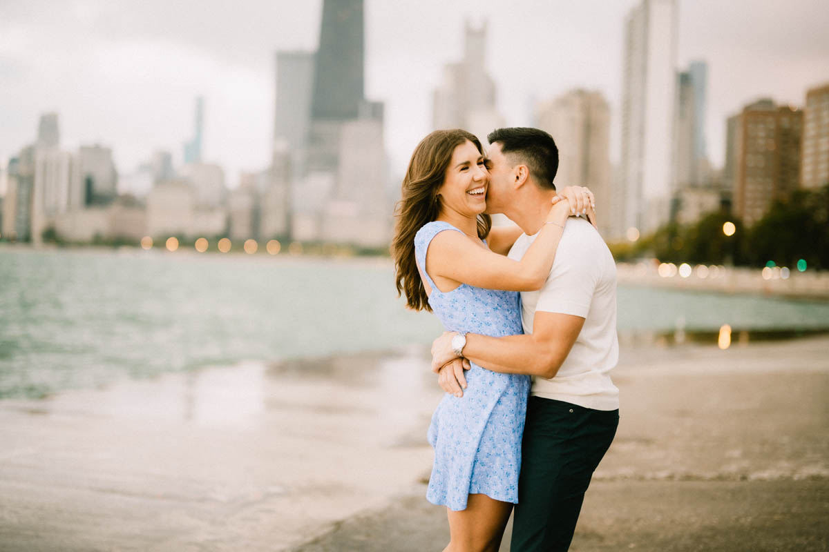 Chicago engagement portrait of a couple laughing and embracing along the lake