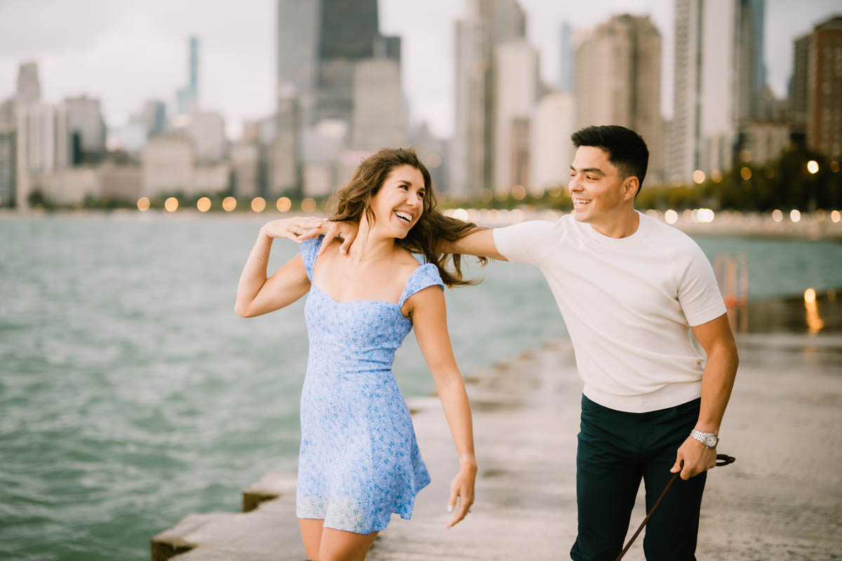 Chicago engagement photo of a couple laughing together along Lake Michigan