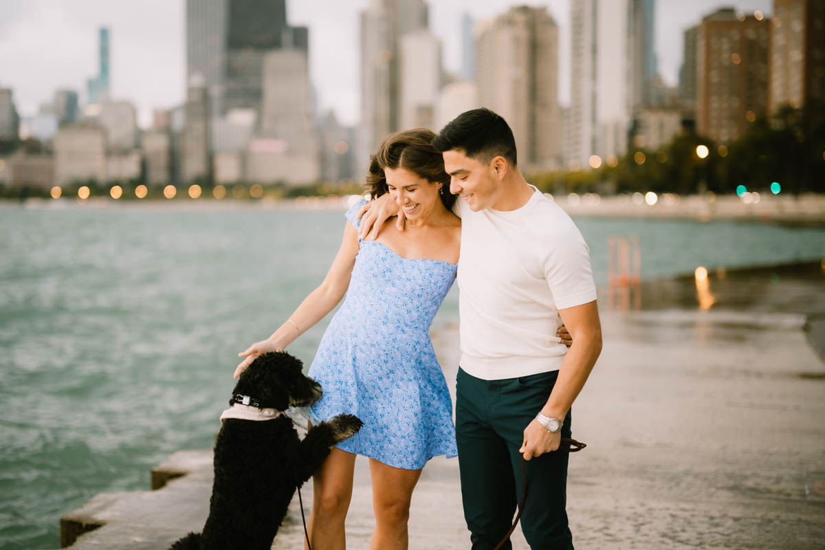 Chicago engagement photo of a couple walking together along the Lake Michigan shoreline