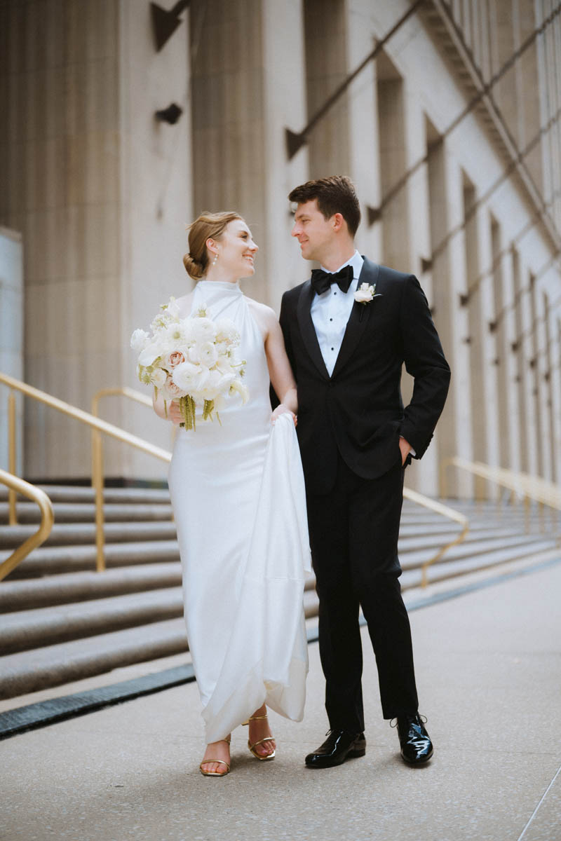 Bride and groom standing together on the staircase at the Old Post Office Chicago