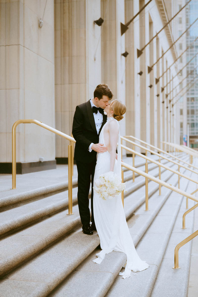 Bride and groom sharing a quiet moment on the staircase at the Old Post Office Chicago