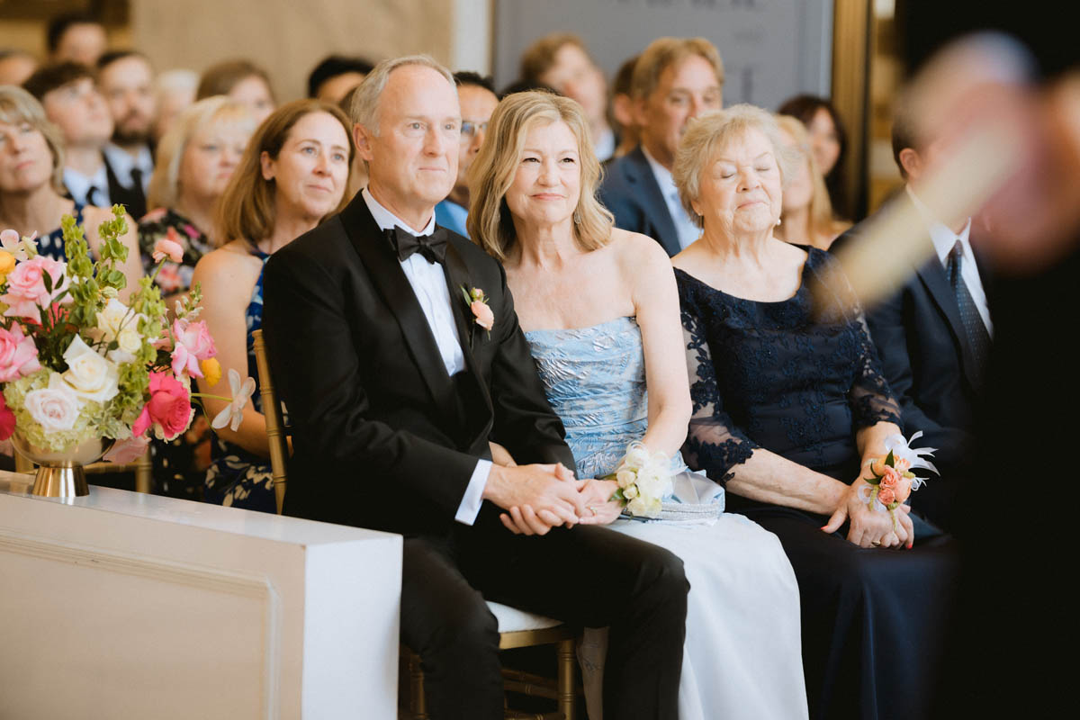 Bride's parents smiling and watching the ceremony at the Old Post Office Chicago