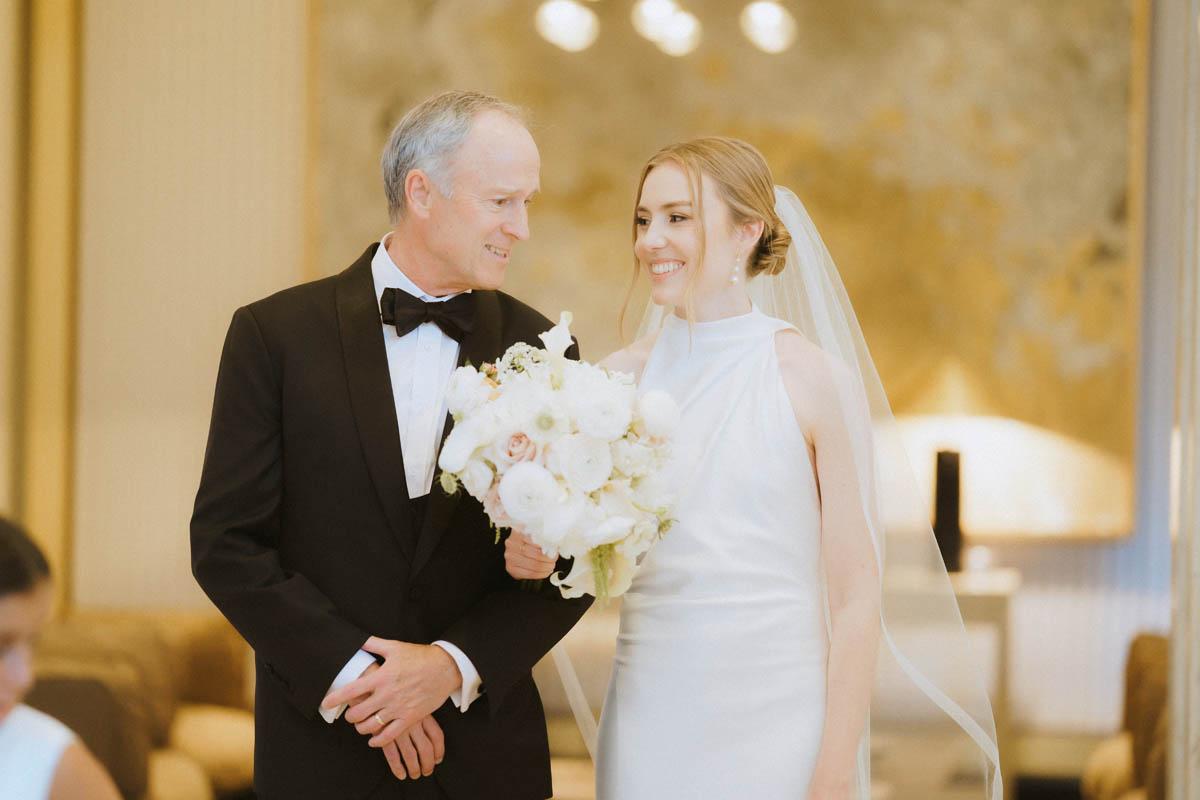 Bride and dad smiling together during wedding day at the Old Post Office Chicago