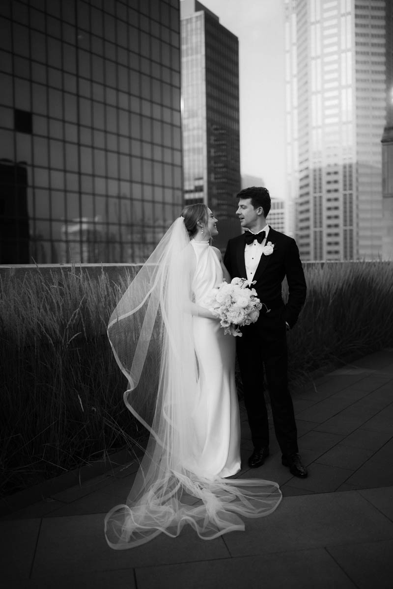 Black and white portrait of bride and groom on the rooftop