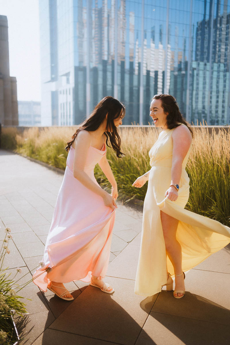 Two bridesmaids laughing together outside during a Chicago wedding reception