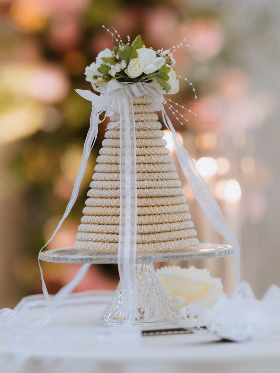 Close-up of elegant wedding cake decorated with white flowers