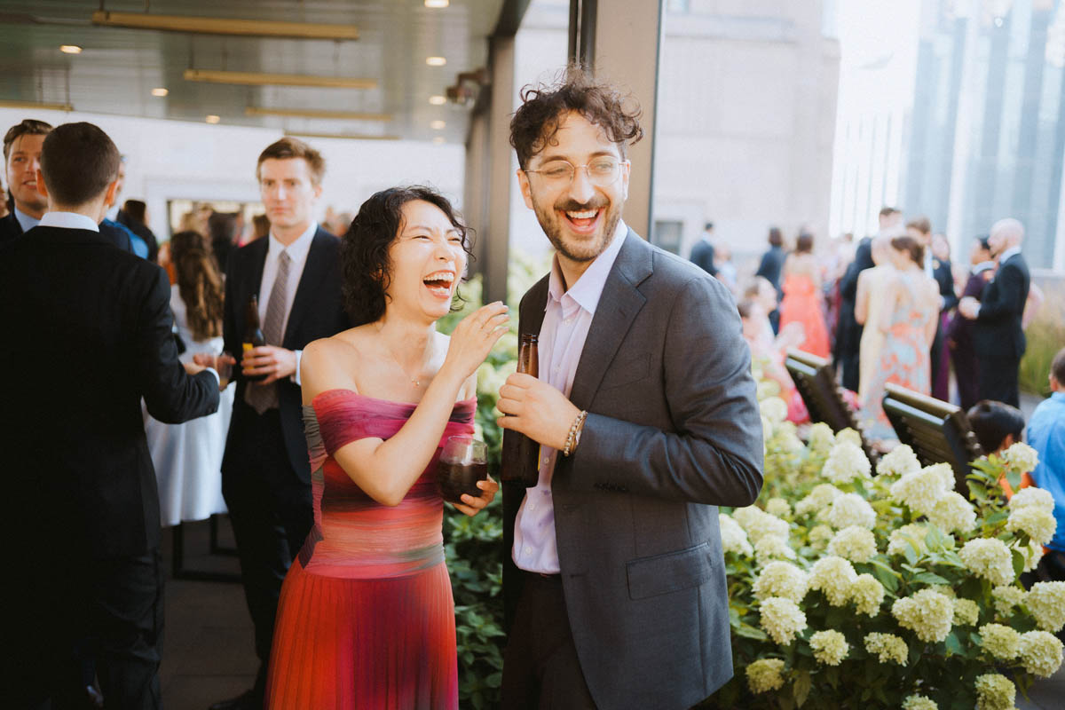 Wedding guests laughing and talking during the rooftop reception at the Old Post Office Chicago