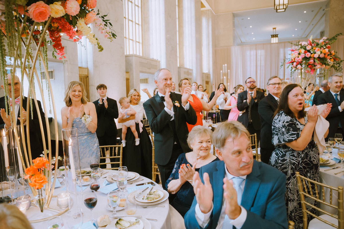 Wedding guests pumped up as the bride and groom enter the reception