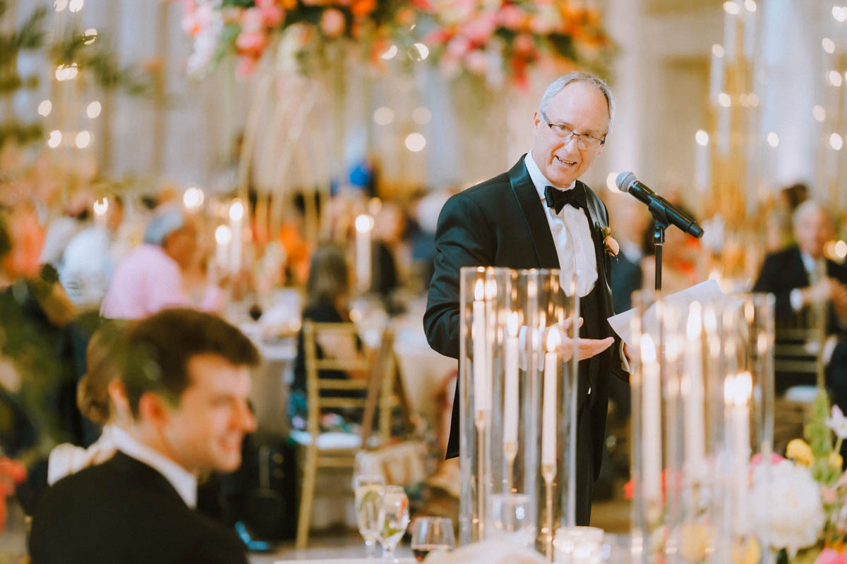 Dad giving a wedding toast to the couple.