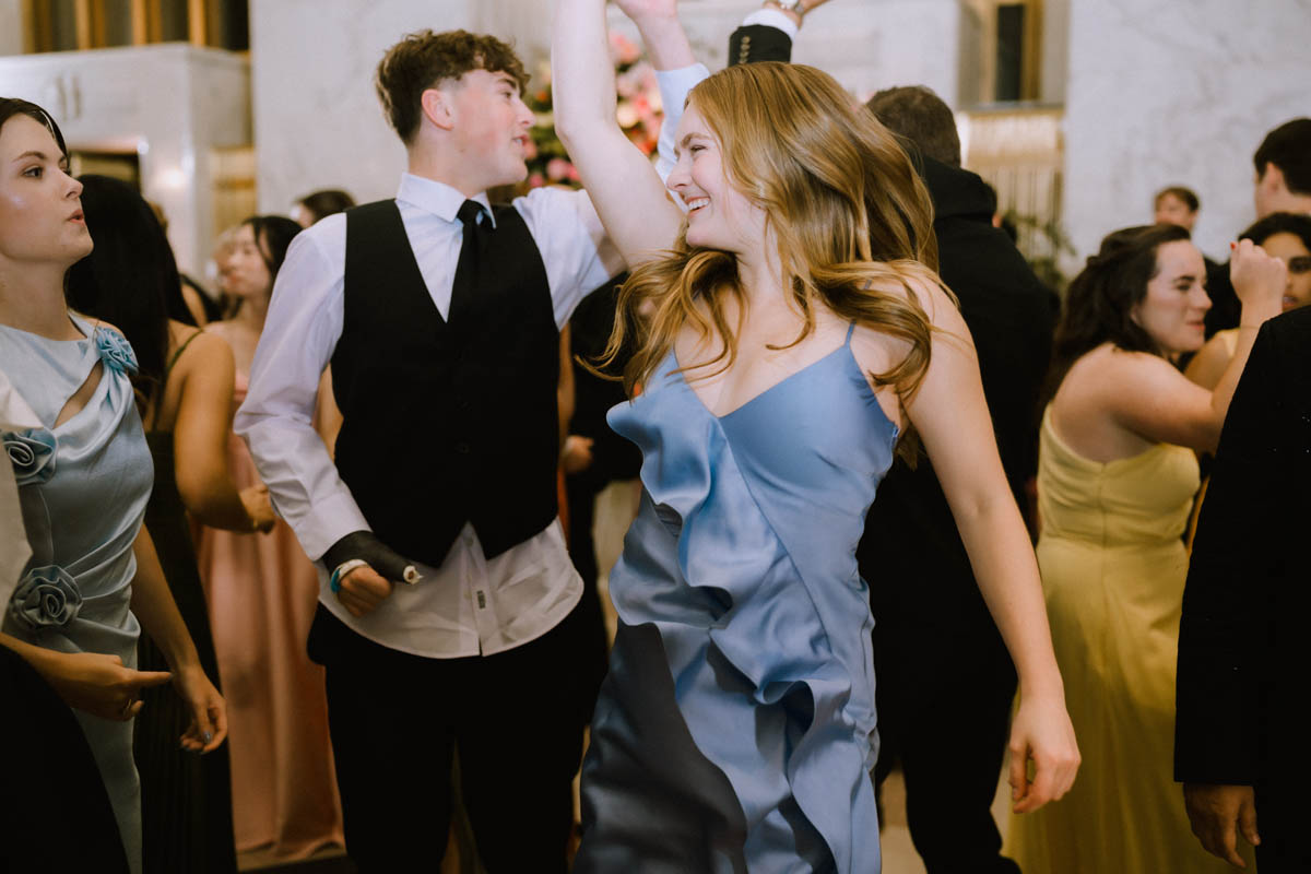 Wedding guests laughing and dancing together at the reception
