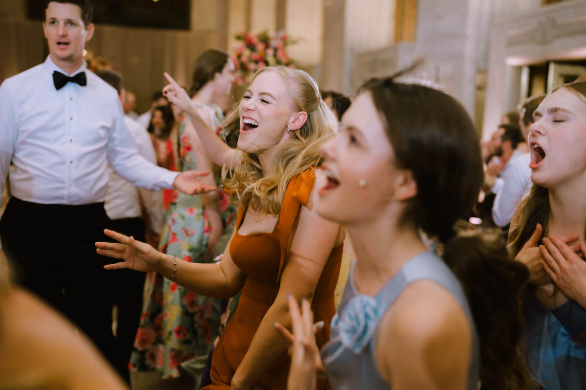 Guest laughing while dancing at the wedding reception