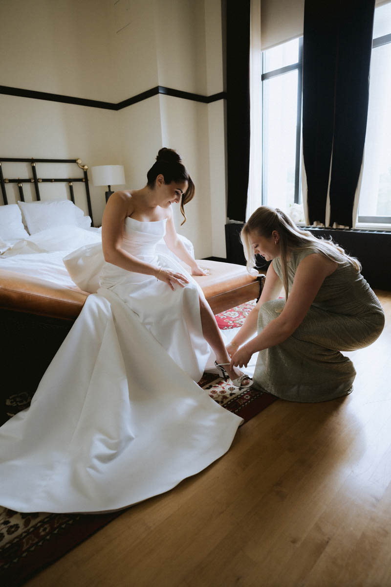 Bride getting ready with a maid of honor during bridal preparations at the Chicago Athletic Association Hotel