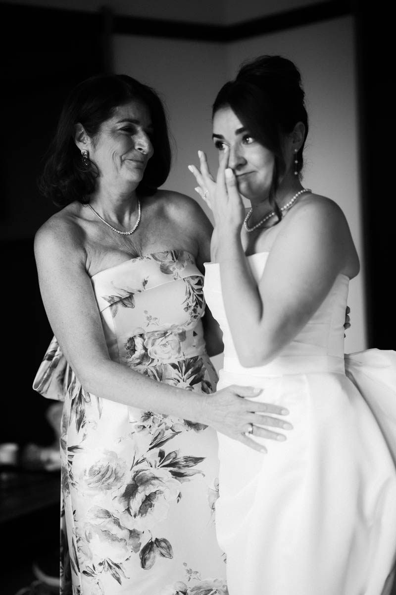 Black and white photos of bride wiping tears