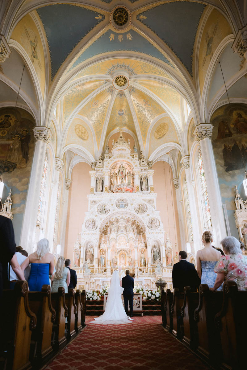 Bride and groom standing together during their wedding ceremony at St. Michael’s Church