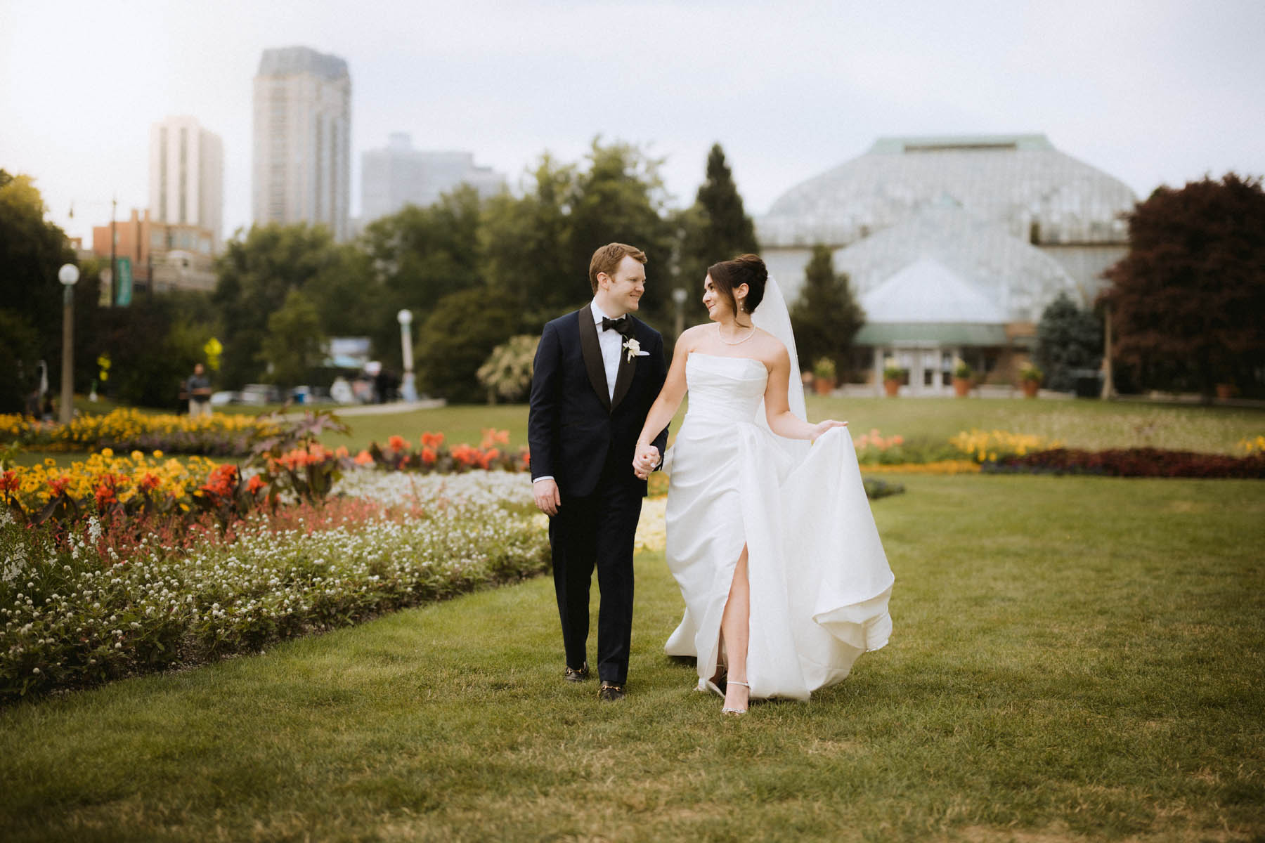 Bride and groom walking together by Lincoln Park Conservatory
