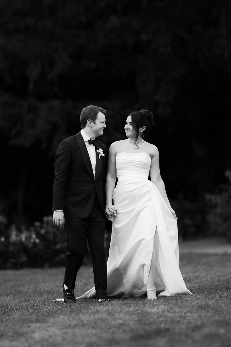 Romantic photo of bride and groom walking through Lincoln Park