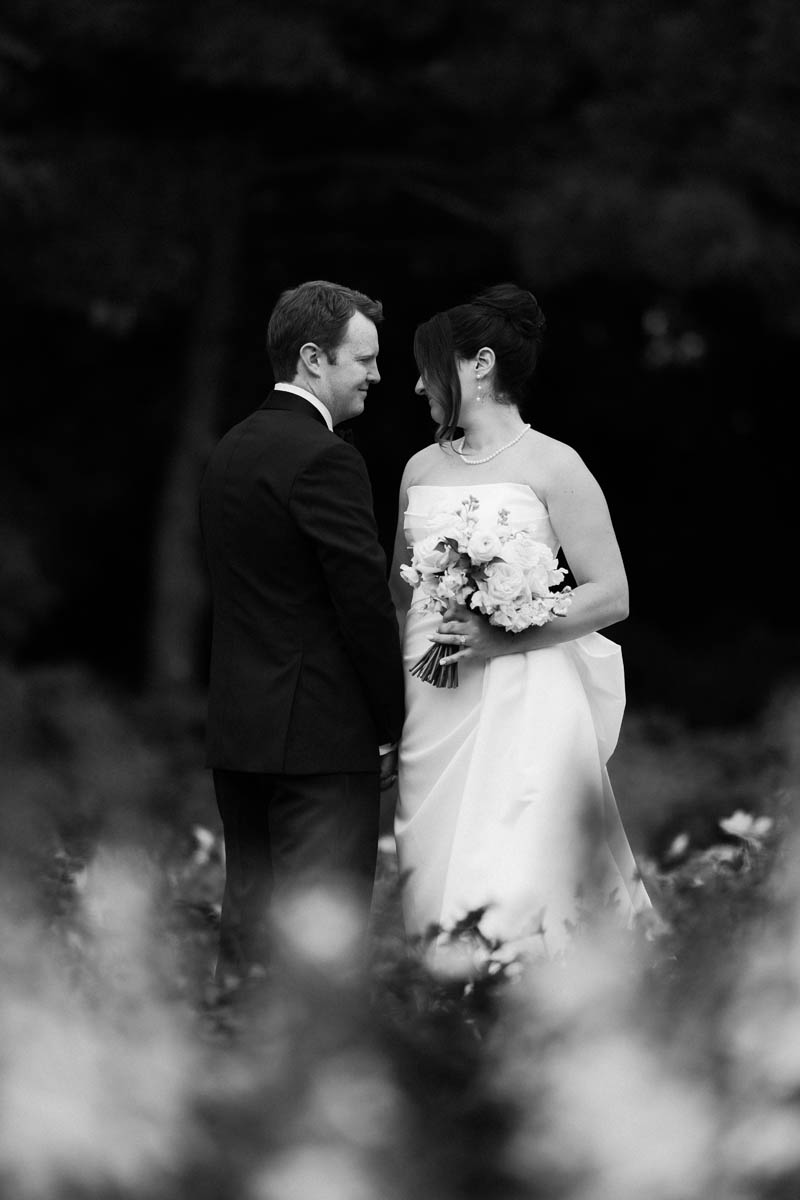 Black and white moody photo of bride and groom