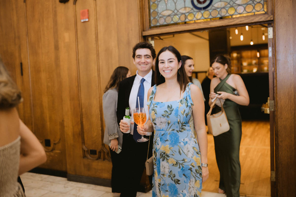 Wedding guests laughing and talking during the reception at the Chicago Athletic Association Hotel