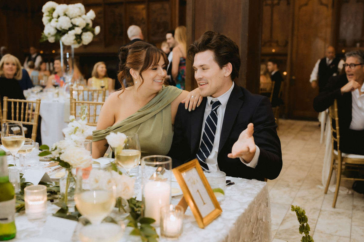 Wedding guests laughing and talking during the reception at the Chicago Athletic Association Hotel