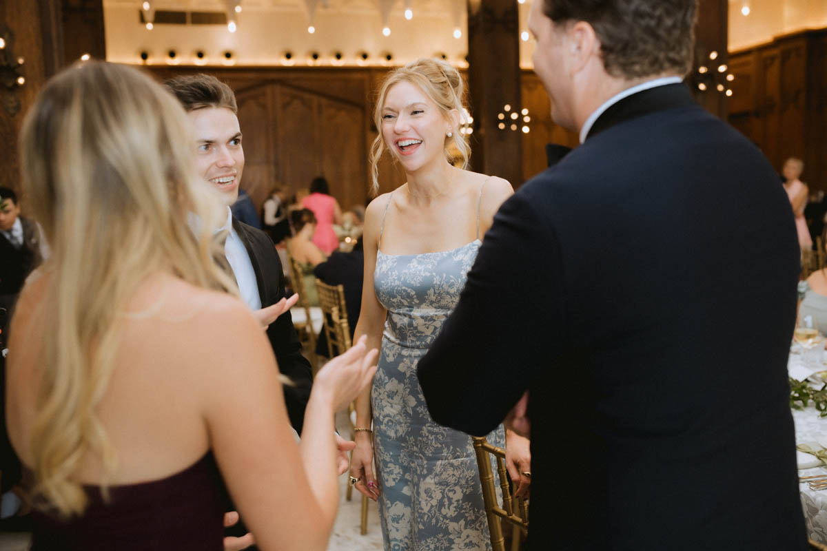 Wedding guests laughing together at the Chicago Athletic Association Hotel reception