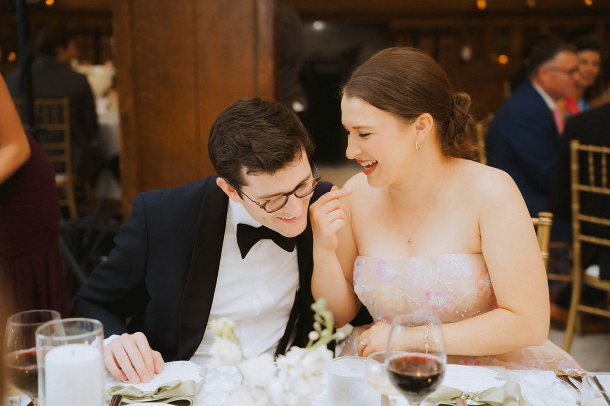 Guests laughing together during their Chicago Athletic Association Hotel wedding reception