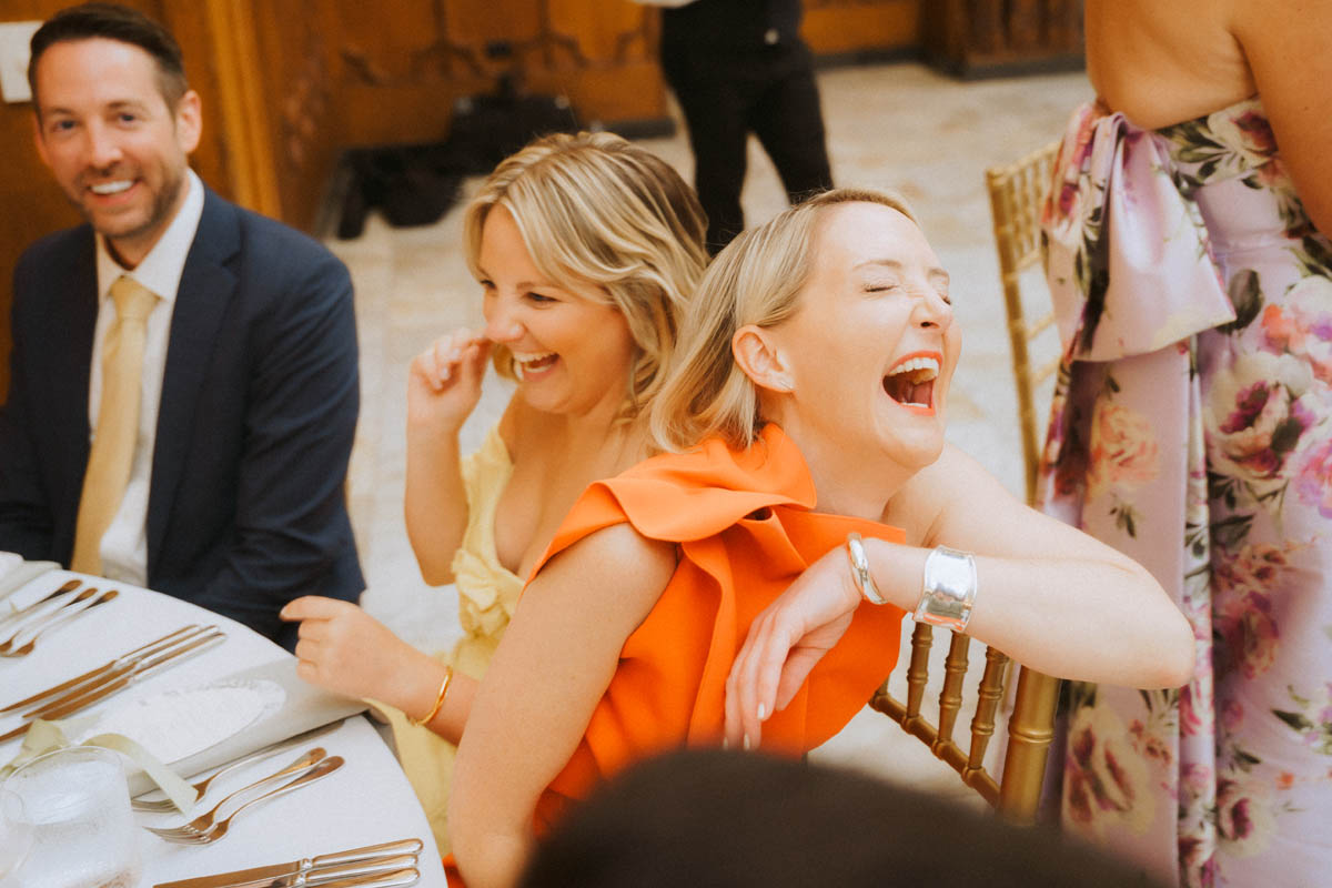 Wedding guests laughing together during the reception at the Chicago Athletic Association Hotel
