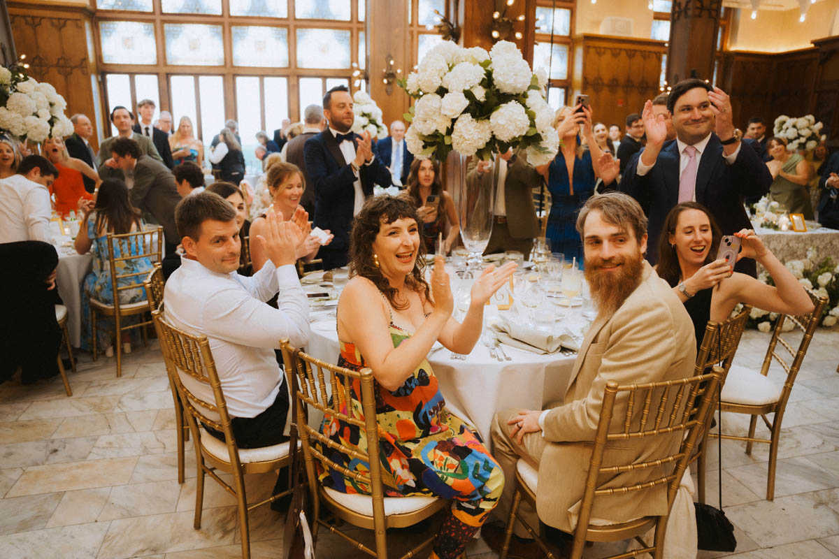 Wedding guests celebrating and raising their hands during a Chicago wedding reception