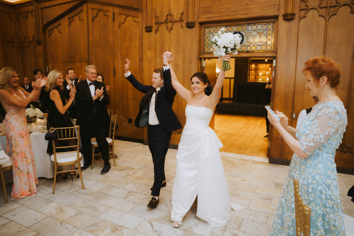 Bride and groom entering their wedding reception at the Chicago Athletic Association Hotel