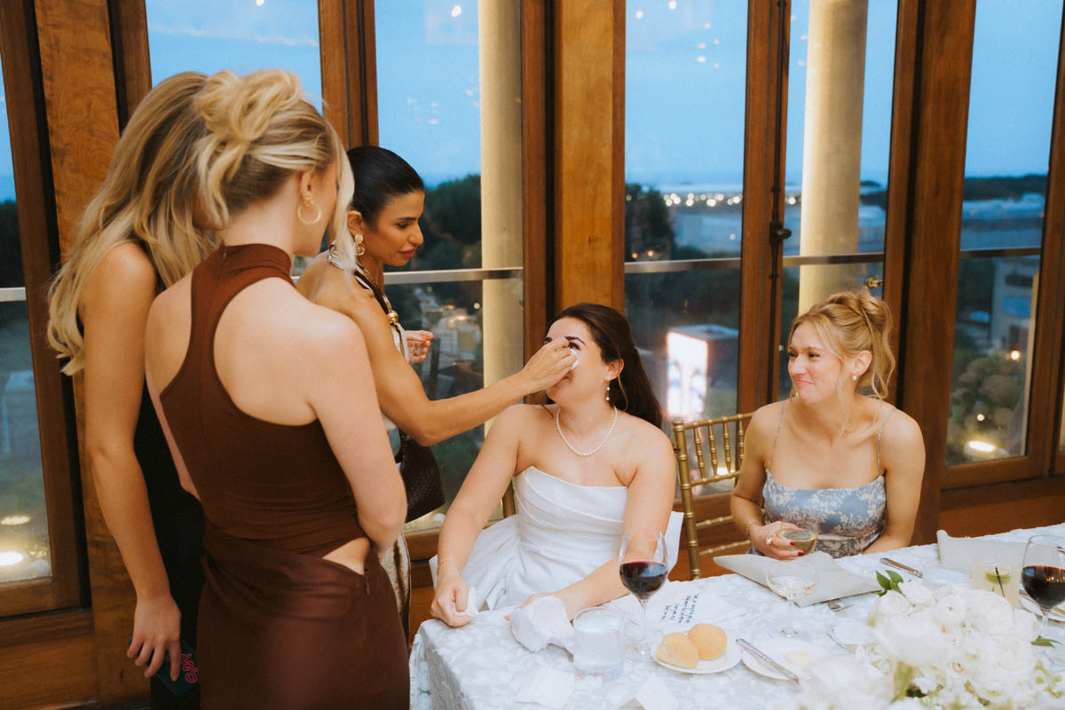 Bride and wedding guests sharing a candid moment during the reception