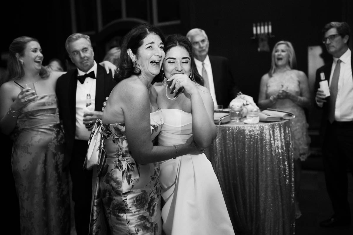 Bride laughing with her mom during the wedding reception at the Chicago Athletic Association Hotel
