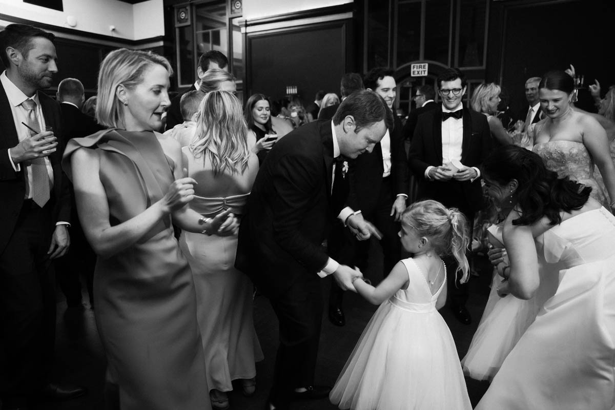 Groom and flower girl dancing during the Chicago Athletic Association Hotel reception
