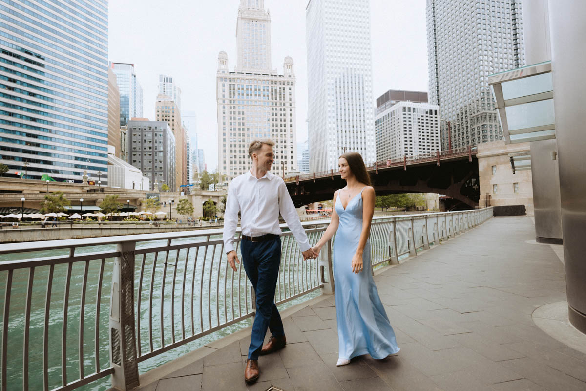 Engagement couple walking by Chicago riverwalk
